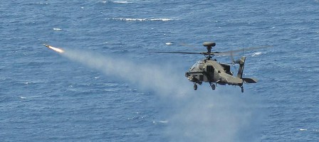 An Army Air Corps Apache attack helicopter launches a Hellfire missile while flying from HMS Ocean. The UK assault carrier is now off Libya. Photo: UK MoD.